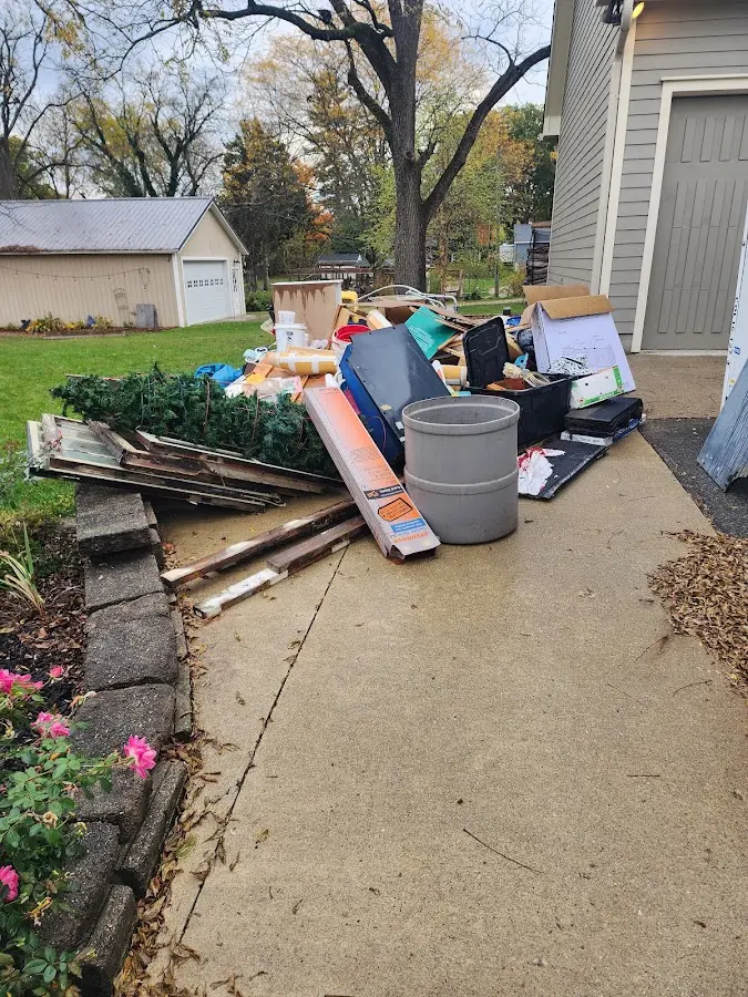 Dumpster being loaded with debris for 30 Yard Dumpster Rental in Ishpeming